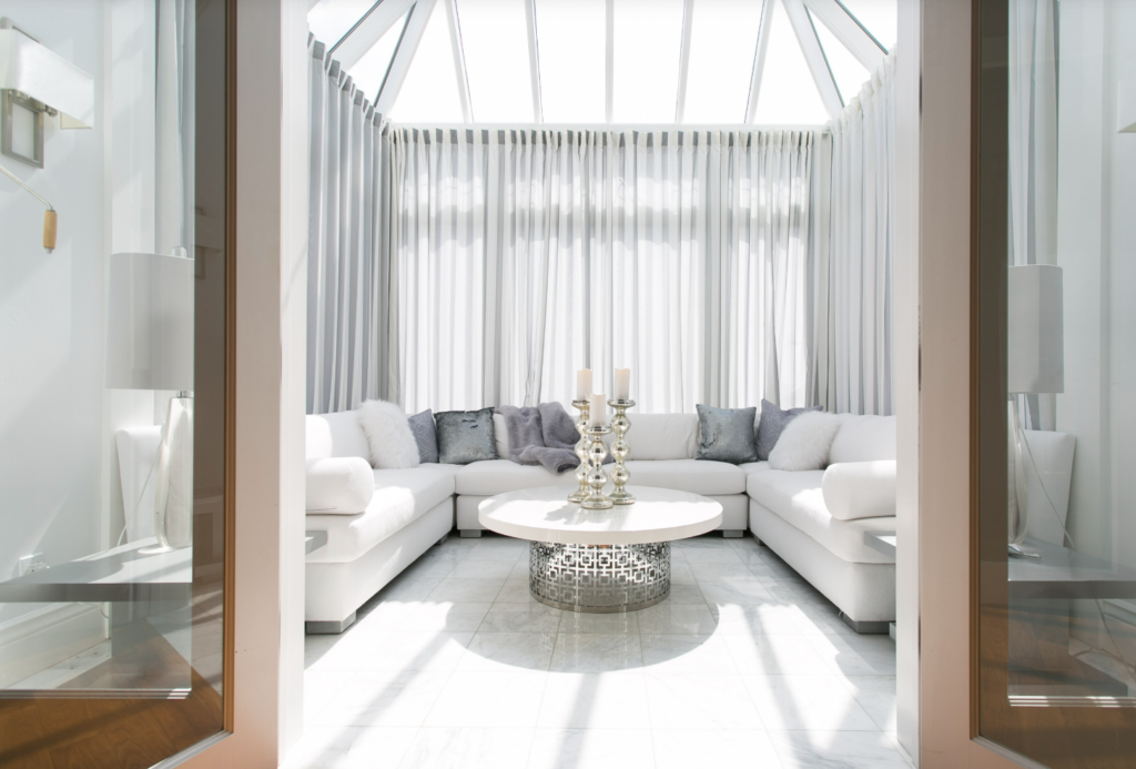 Bright Sunroom With Sheer Curtains 